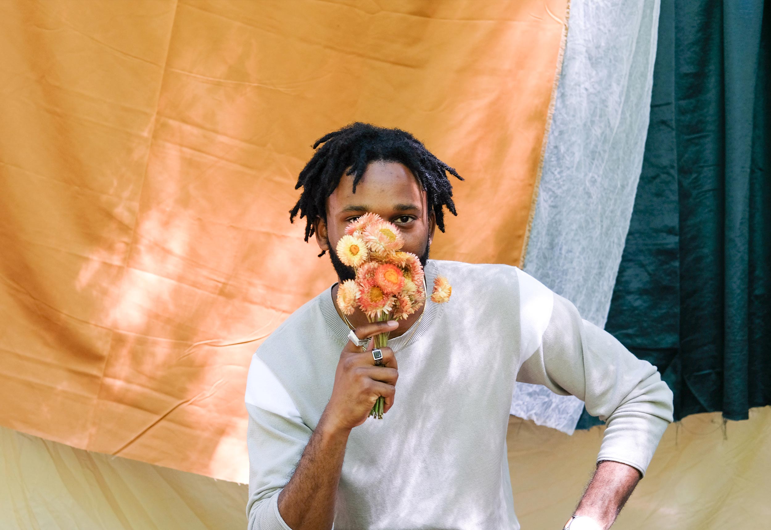 person-holding-flowers-to-face